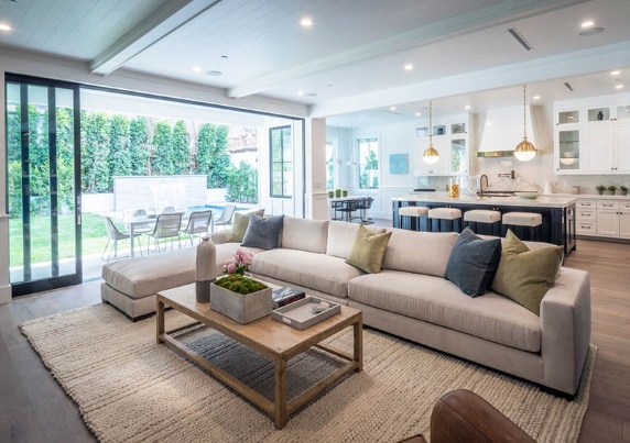 transitional-open-concept-living-room-with-wainscoting-and-kitchen-with-white-cabinets